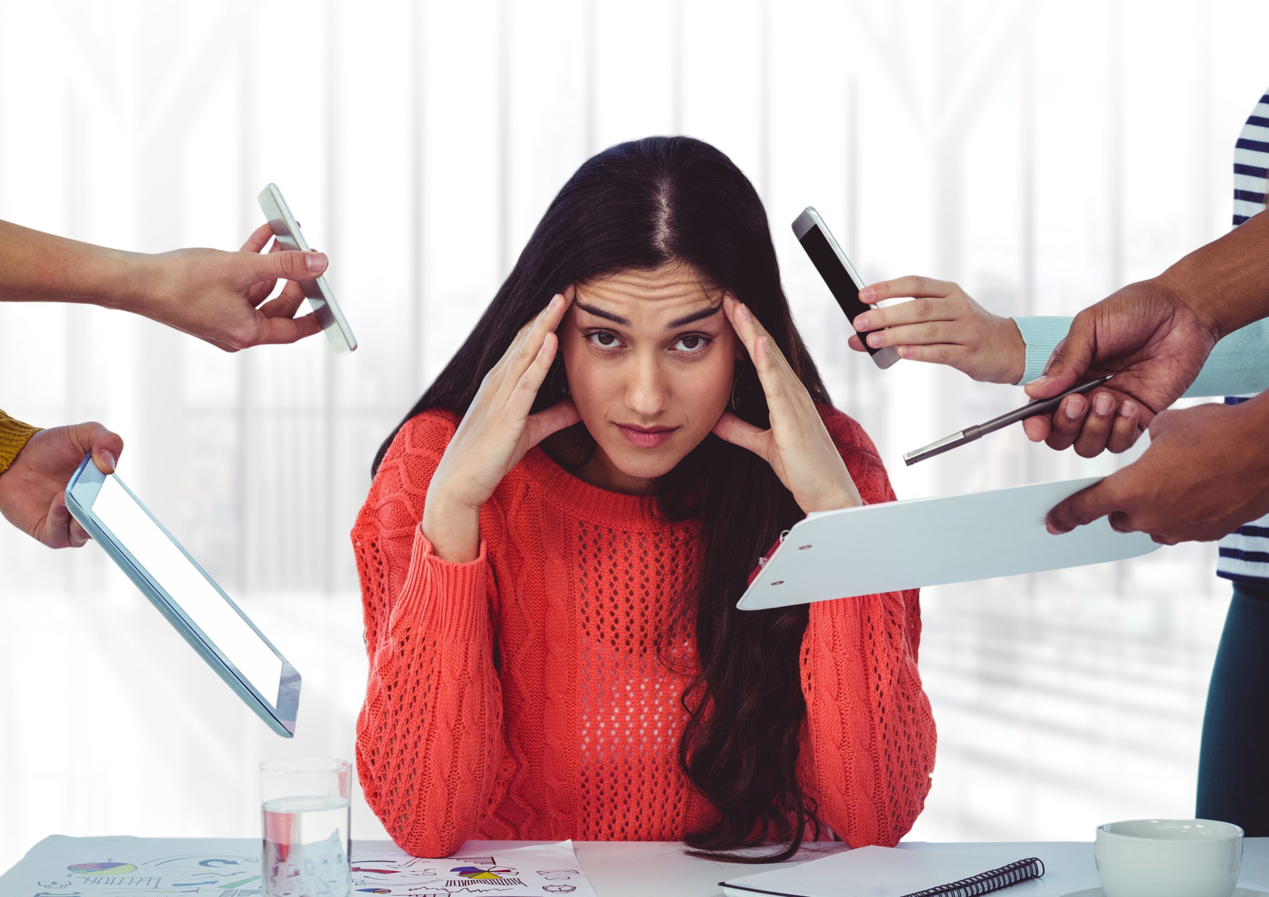 Stressed out woman sitting with hands on forehead needing stress relief